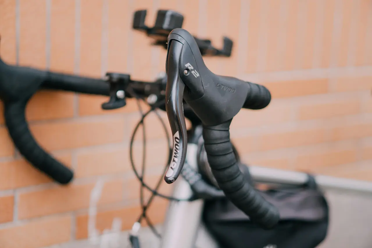 Brake lever on a drop handlebar wrapped in black bar tape