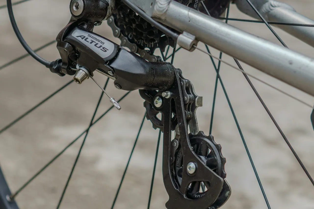 Rear derailleur guiding the chain through its two small pulley wheels